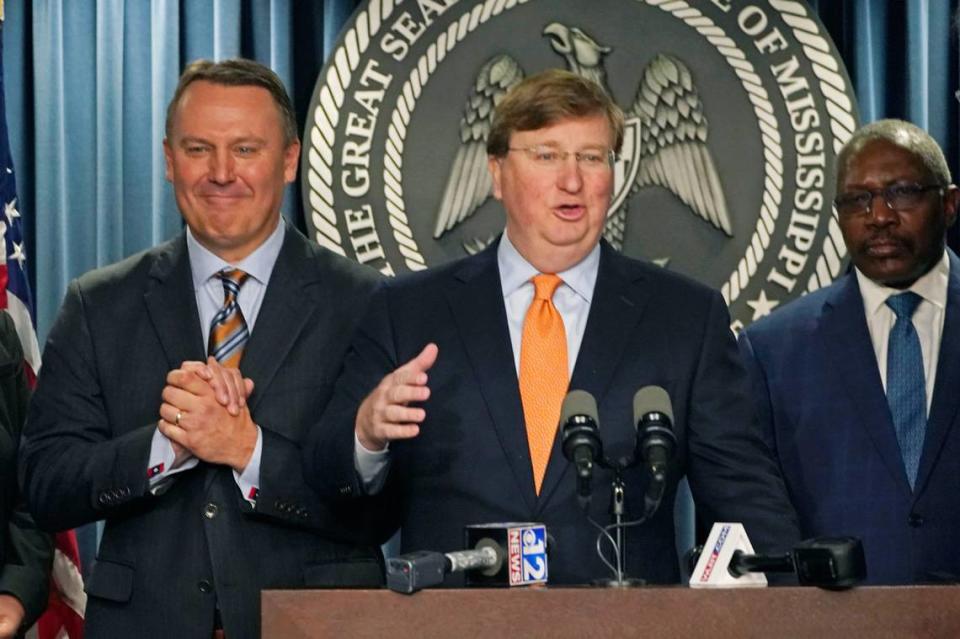 Mississippi Gov. Tate Reeves, center, announces a tech company will invest $10 billion to build two data processing centers that will create 1,000 jobs in central Mississippi, during a Wednesday news conference in Jackson. Rogelio V. Solis/AP