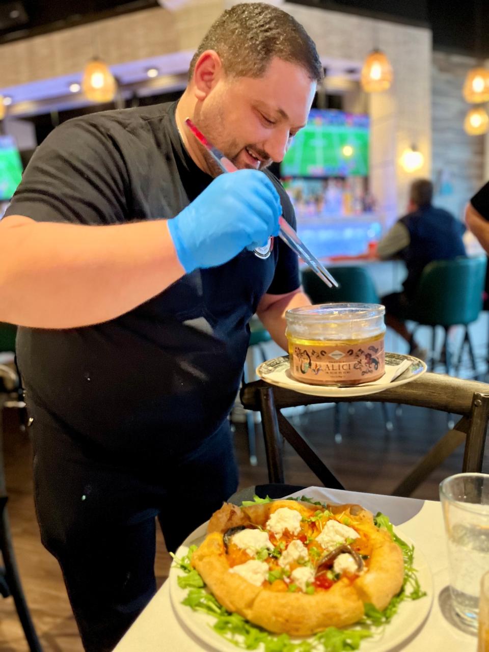 Chef and co-owner Giuseppe Manco adds anchovies to Montanara di Cetara at San Matteo.