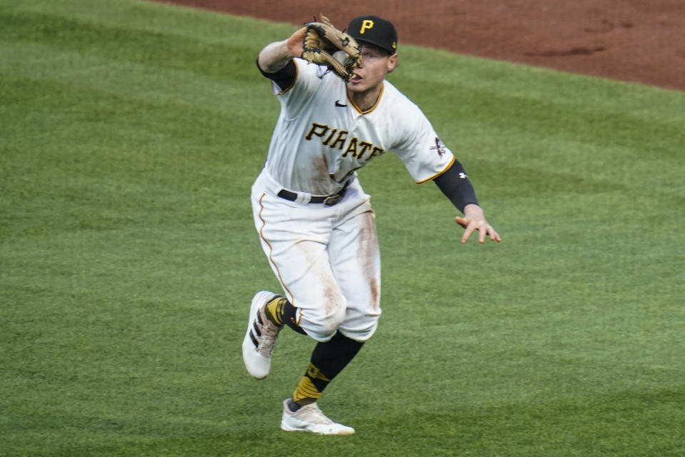 Pittsburgh Pirates right fielder Jack Suwinski snares a line drive by Cincinnati Reds' Tyler Naquin during the fourth inning of a baseball game Thursday, May 12, 2022, in Pittsburgh. (AP Photo/Keith Srakocic)