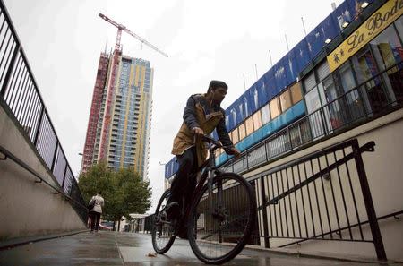 A man rides his bike past a view of the Elephant Park building development in Elephant and Castle south London, Britain October 5, 2015. REUTERS/Neil Hall