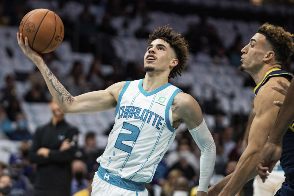 Charlotte Hornets guard LaMelo Ball drives to the basket while guarded by Indiana Pacers guard Chris Duarte during the first half of an NBA basketball game in Charlotte, N.C., Wednesday, Oct. 20, 2021. (AP Photo/Jacob Kupferman)