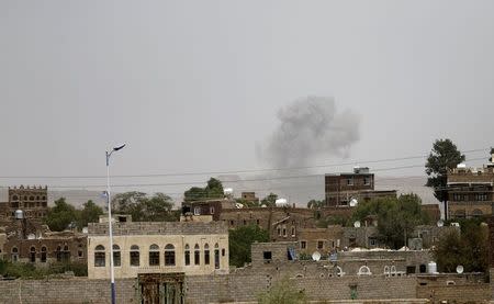 Smoke rises from a military post after it was hit by an air strike in Sanaa April 11, 2015. REUTERS/Khaled Abdullah