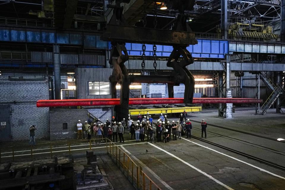 FILE - A group of foreign journalists visit the Alchevsk Metallurgical Complex, on the territory which is under the Government of the Luhansk People's Republic control, eastern Ukraine, on June 11, 2022. Even as the Russian war machine crawls across Ukraine’s east, trying to achieve the Kremlin’s goal of securing a full control over the country’s industrial heartland of the Donbas, the Ukrainian forces are scaling up attacks to reclaim territory in the south. (AP Photo, File)