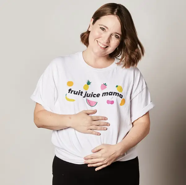 Katie Aubin wearing a T-shirt that says "fruit juice mama"