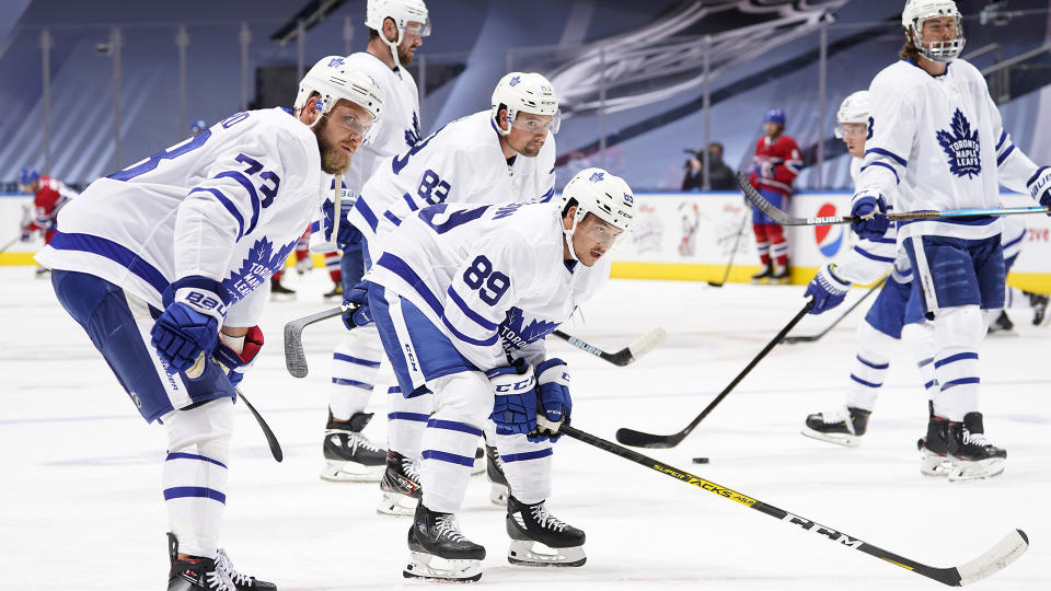 TORONTO, ONTARIO - JULY 28: (L-R) Kyle Clifford #73, Cody Ceci #83 and Nick Robertson #89 of the Toronto Maple Leafs look on during warm-up prior to an exhibition game against the Montreal Canadiens prior to the 2020 NHL Stanley Cup Playoffs at Scotiabank Arena on July 28, 2020 in Toronto, Ontario. (Photo by Mark Blinch/NHLI via Getty Images)