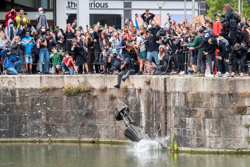 FILE PHOTO: The statue of Edward Colston falls into the water after protesters pulled it down in Bristol