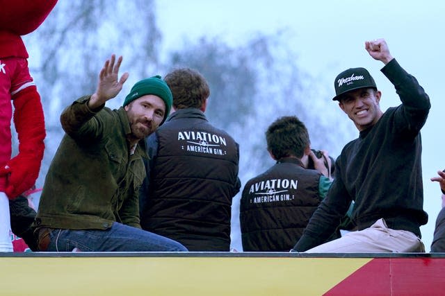 Wrexham owners Ryan Reynolds and Rob McElhenney celebrate during the victory parade 