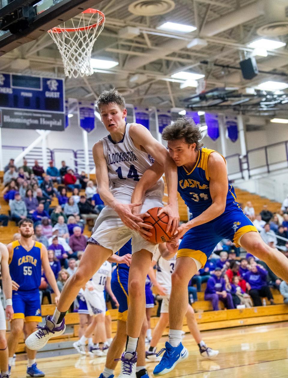 South's Gavin Wisely (14) battles for a rebound with Castle's Brendan Daines (34) during the Bloomington South versus Castle boys basketball game at Bloomington High School South on Friday, Jan. 20, 2023.