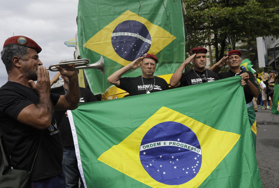 Army veterans attend a rally in support of the government's "Car Wash" investigation into corruption on Copacabana beach, Rio de Janeiro, Brazil, Sunday, Aug. 25, 2019. Supporters of the president and the justice minister called for the nationwide demonstration. (AP Photo/Silvia Izquierdo)