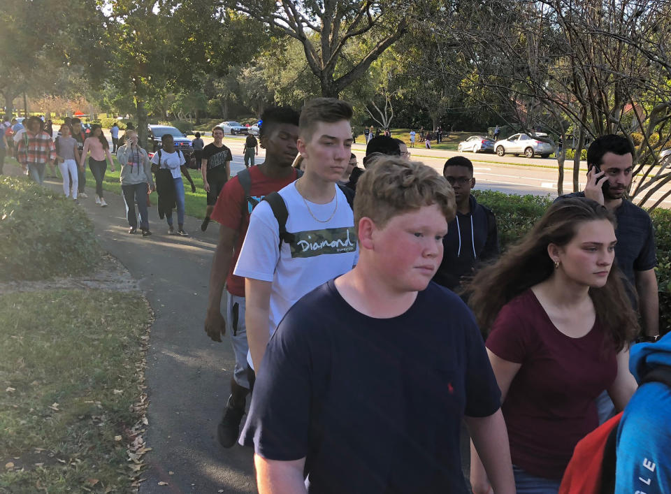 <p>Students leave Marjory Stoneman Douglas High School in Parkland, Florida, a city about 50 miles (80 kilometers) north of Miami on Feb. 14, 2018 following a school shooting. (Photo: Michele Eve Sandberg/AFP/Getty Images) </p>