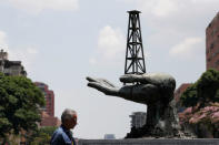 A man walks past a sculpture outside a building of Venezuela's state oil company PDVSA in Caracas, Venezuela May 17, 2019. REUTERS/Ivan Alvarado