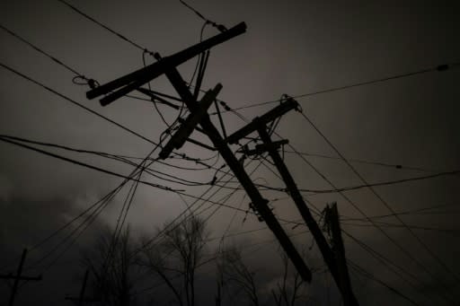 Damaged utility poles and lines hang above a street on March 3, 2020 in Nashville