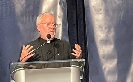 The Rev. Tim McCabe, executive director of the Pope Francis Center in downtown Detroit, speaks to a crowd of 850 at Ford Field on Thursday, April 20, 2023.