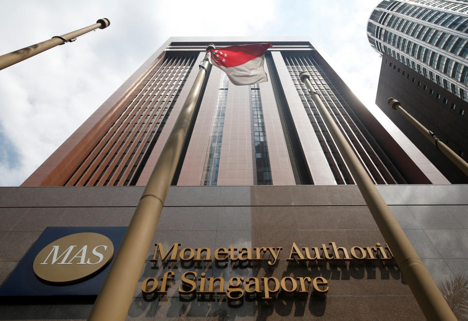 An image of the facade of the MAS building with its logo and name as well as the Singapore flag. 