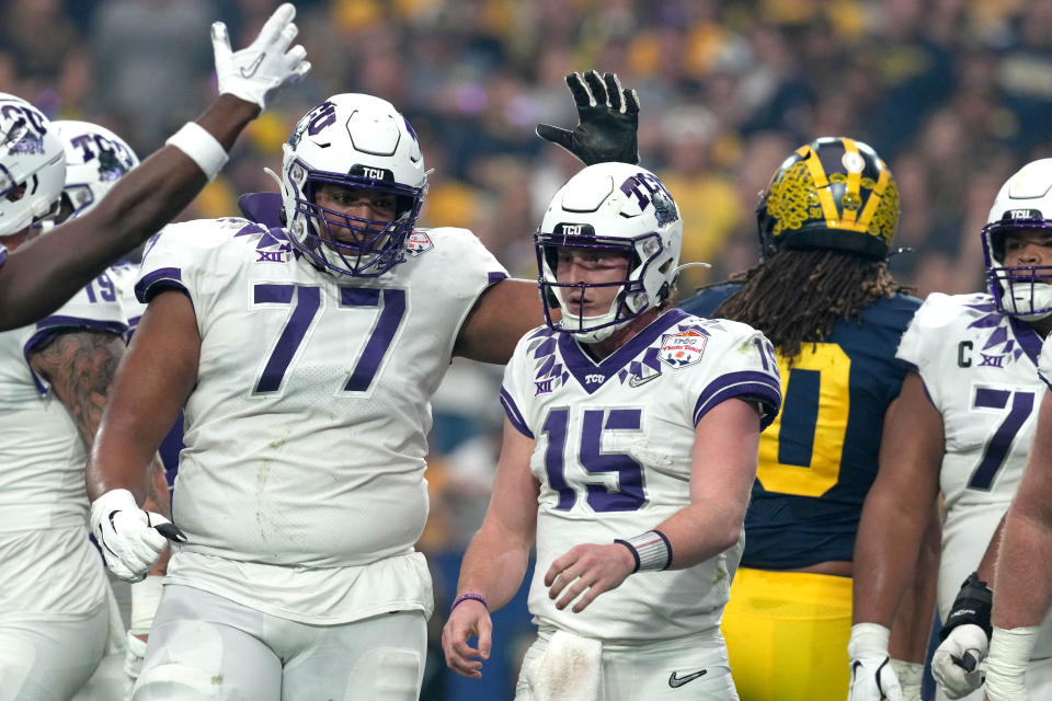 Dec 31, 2022; Glendale, Arizona, USA; TCU Horned Frogs quarterback Max Duggan (15) is congratulated by offensive tackle Brandon Coleman (77) after scoring a touchdown against the Michigan Wolverines in the first quarter of the 2022 Fiesta Bowl at State Farm Stadium. Mandatory Credit: Kirby Lee-USA TODAY Sports