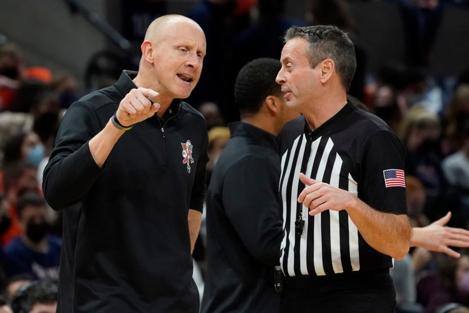 Louisville head coach Chris Mack argues with a ref during the second half of an NCAA college basketball game Monday Jan. 24, 2022, in Charlottesville, Va. Virginia defeated Louisville 64-52. (AP Photo/Steve Helber)