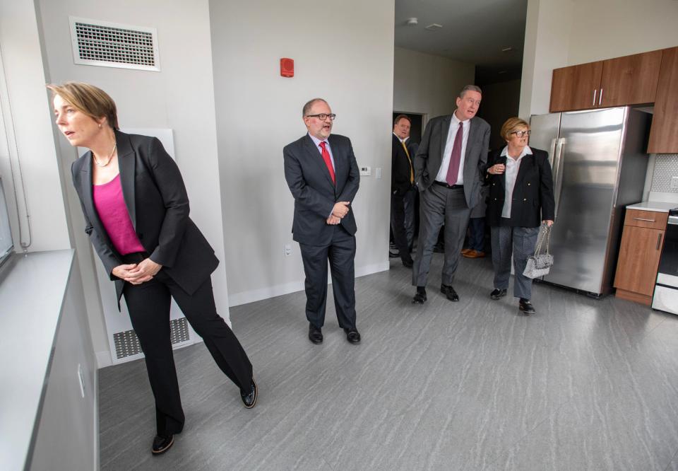 Gov. Maura Healey looks at the view from an apartment inside the Courthouse Lofts during a tour with Trinity Financial Vice President Michael Lozano, Housing Secretary Edward M. Augustus Jr. and District 2 City Councilor Candy Mero-Carlson, left to right, Wednesday.