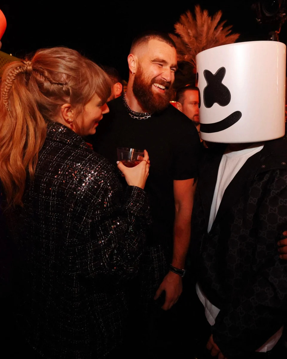 Travis Kelce and Taylor Swift hang out at a party