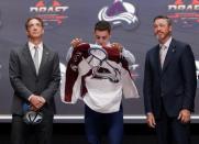 Jun 24, 2016; Buffalo, NY, USA; Tyson Jost puts on a team jersey after being selected as the number ten overall draft pick by the Colorado Avalanche in the first round of the 2016 NHL Draft at the First Niagra Center. Mandatory Credit: Timothy T. Ludwig-USA TODAY Sports