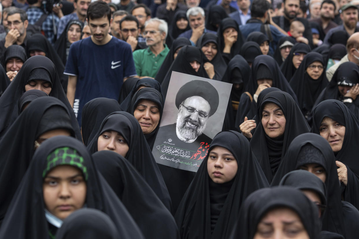 People carrying images of Iranian President Ebrahim Raisi in Tehran on May 20, 2024, after he was killed in a helicopter crash. (Arash Khamooshi/The New York Times)