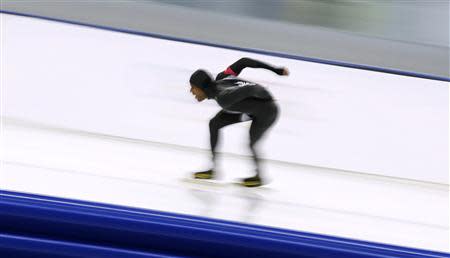 Shani Davis of the U.S.skates during the men's 1,000 metres speed skating race at the Adler Arena during the 2014 Sochi Winter Olympics February 12, 2014. REUTERS/Issei Kato