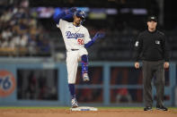 Los Angeles Dodgers' Mookie Betts reacts after driving in a run with a double during the second inning of the team's baseball game against the Washington Nationals, Tuesday, April 16, 2024, in Los Angeles. (AP Photo/Marcio Jose Sanchez)