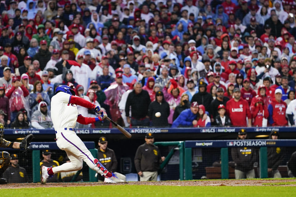 Philadelphia Phillies' Bryce Harper hits a two-run home run during the eighth inning in Game 5 of the baseball NL Championship Series between the San Diego Padres and the Philadelphia Phillies on Sunday, Oct. 23, 2022, in Philadelphia. (AP Photo/Matt Slocum)