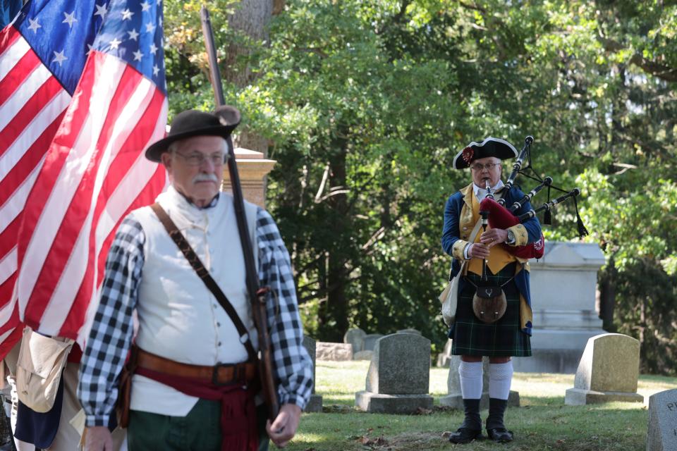The MISSAR Color Guard stands at attention while another MISSAR member plays the bagpipes on Sept. 24, 2023.