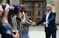 London's new mayor Sadiq Khan (R) greets well-wishers outside Southwark Cathedral on May 7, 2016 after his swearing-in ceremony