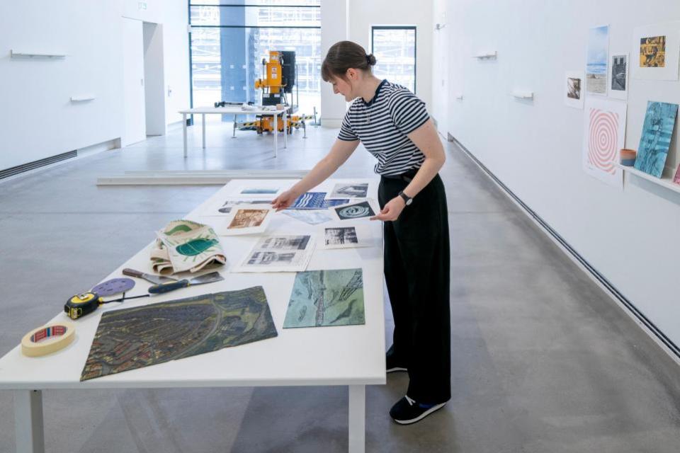 The Herald: A gallery assistant helps to prepare the exhibition space at the Edinburgh Printmakers