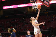 Maryland forward Chloe Bibby (55) goes to the basket past Mount St. Mary's guard Jessica Tomasetti, center, and guard Jada Lee, left, during the first half of an NCAA college basketball game Tuesday, Nov. 16, 2021, in College Park, Md. (AP Photo/Nick Wass)