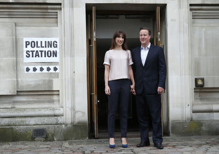 Britain's Prime Minister David Cameron and his wife Samantha leave after voting in the local council and European elections, at a polling station in London May 22, 2014. REUTERS/Suzanne Plunkett