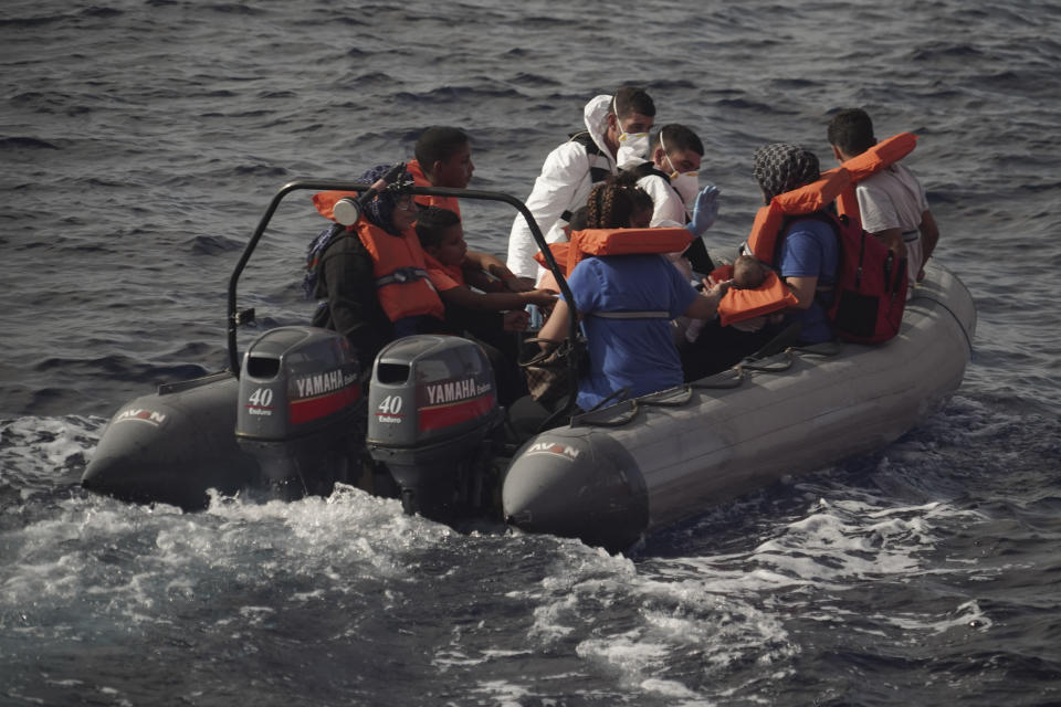 Members of the Maltese Armed Forces take a group of migrants to a Maltese military ship in the Mediterranean Sea, Friday, Sept. 20, 2019. Malta has agreed to take in 35 migrants fleeing Libya who were rescued by the Ocean Viking humanitarian ship a day earlier. (AP Photo/Renata Brito)