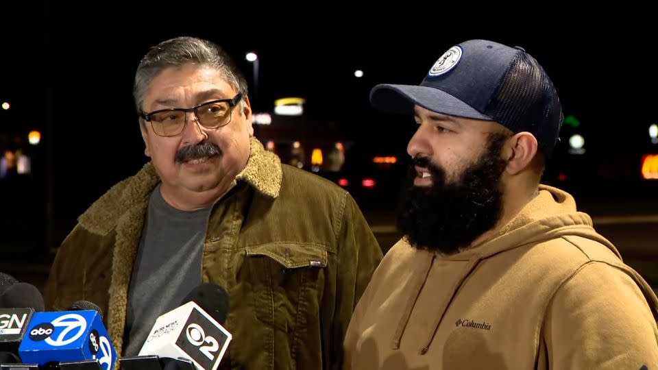 Mario Garcia, left, and his son-in-law Nivardo Delatorre found the man trapped in the mangled truck. - WBBM