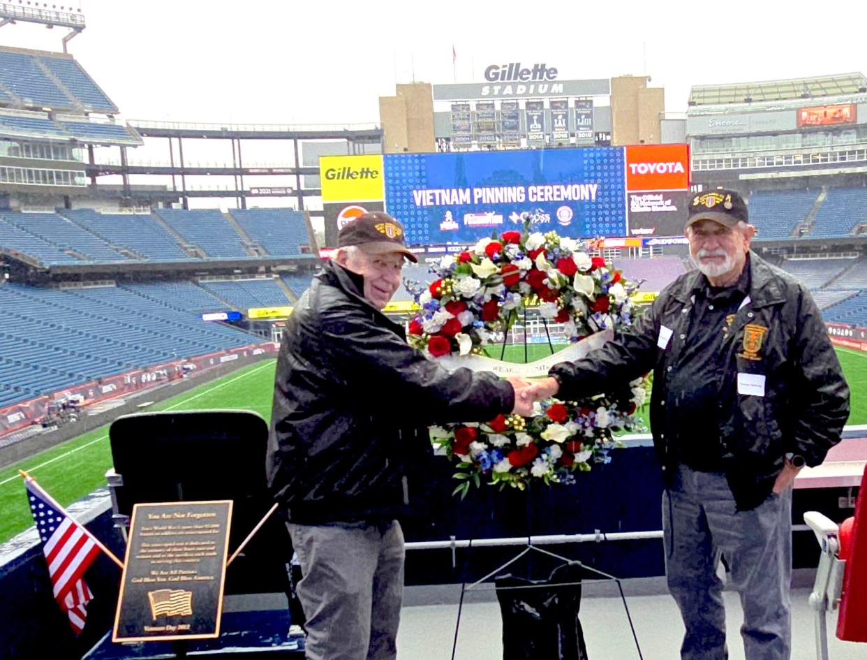 George Lawrence, left, and Tom Duffney stand at the north end of Gillette Stadium on March 28. Both men served with the 107th Signal Company of the R.I. National Guard, which served in Vietnam from 1968 to 1969. The 107th was one of less than a dozen National Guard units nationwide to be activated for Vietnam service. The always-empty black POW/MIA seat is at left.