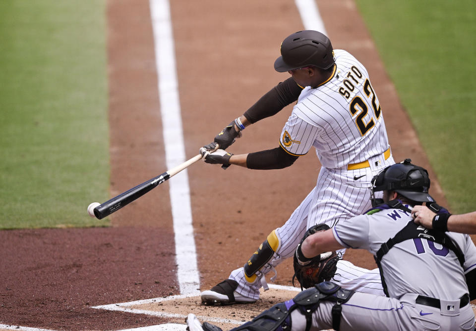 San Diego Padres' Juan Soto (22) drives in a run as he hits into a fielder's choice during the first inning of a baseball game against the Colorado Rockies, Wednesday, Sept. 20, 2023, in San Diego. (AP Photo/Denis Poroy)