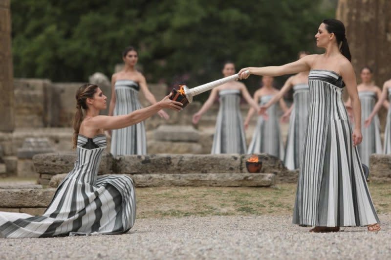 Actors portraying the priestesses of Hera conduct the ceremonial lighting of the Olympic torch early Tuesday in Olympia, Greece. Photo by George Vitsaras/EPA-EFE
