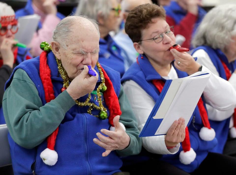 Brenda Timm and her friend Art Panke play kazoos during a On a Positive Note Chorus performance at a memory cafe gathering on Wednesday, December 13, 2023, at the Thompson Center in Appleton, Wis. The memory cafe operated via the Fox Valley Memory Project. It's a social space for people with memory loss/dementia and their caregivers to spend time together in public.