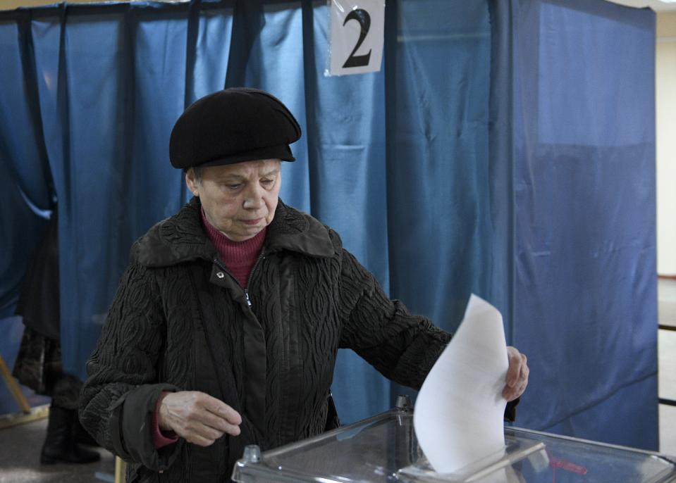 A woman casts her ballot at a polling station during rebel elections in Donetsk, Ukraine, Sunday, Nov. 11, 2018. Residents of the eastern Ukraine regions controlled by Russia-backed separatist rebels are voting for local governments in elections denounced by Kiev and the West. (AP Photo)