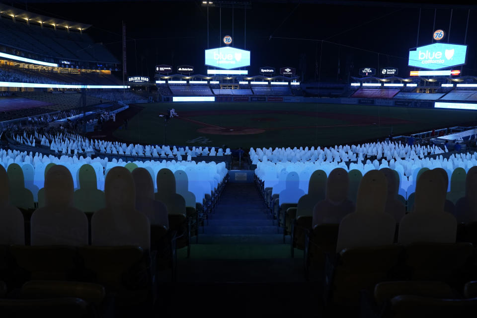 Players leave the field after a power outage during the seventh inning of a baseball game between the Los Angeles Angels and the Los Angeles Dodgers, Saturday, Sept. 26, 2020, in Los Angeles. (AP Photo/Ashley Landis)