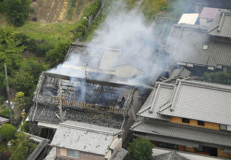 Smoke arise from a house where a fire breaks out, in Takatsuki, Osaka prefecture, western Japan, in this photo taken by Kyodo June 18, 2018. Mandatory credit Kyodo/via REUTERS