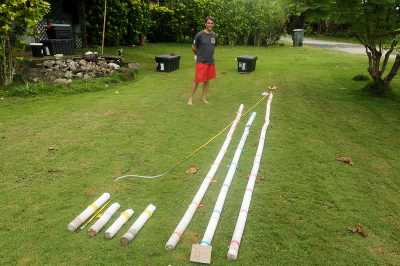 Linsley poses with a collection of coral cores recovered during a research trip in American Samoa in 2011