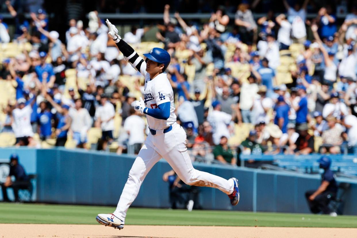 Shohei Ohtani rounds the bases after hitting a solo homer in the eighth inning to extend the Dodgers' lead to 6-4.