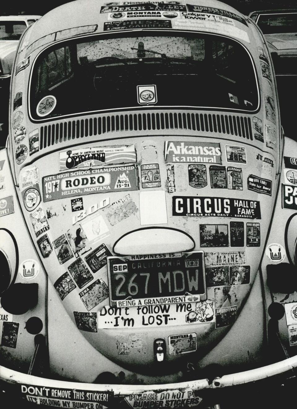 An automobile photographed in 1978 at the state Capitol is covered with stickers beyond just the bumper. Opryland, Arkansas, Maine and other states are represented along with a hodgepodge of other decals.