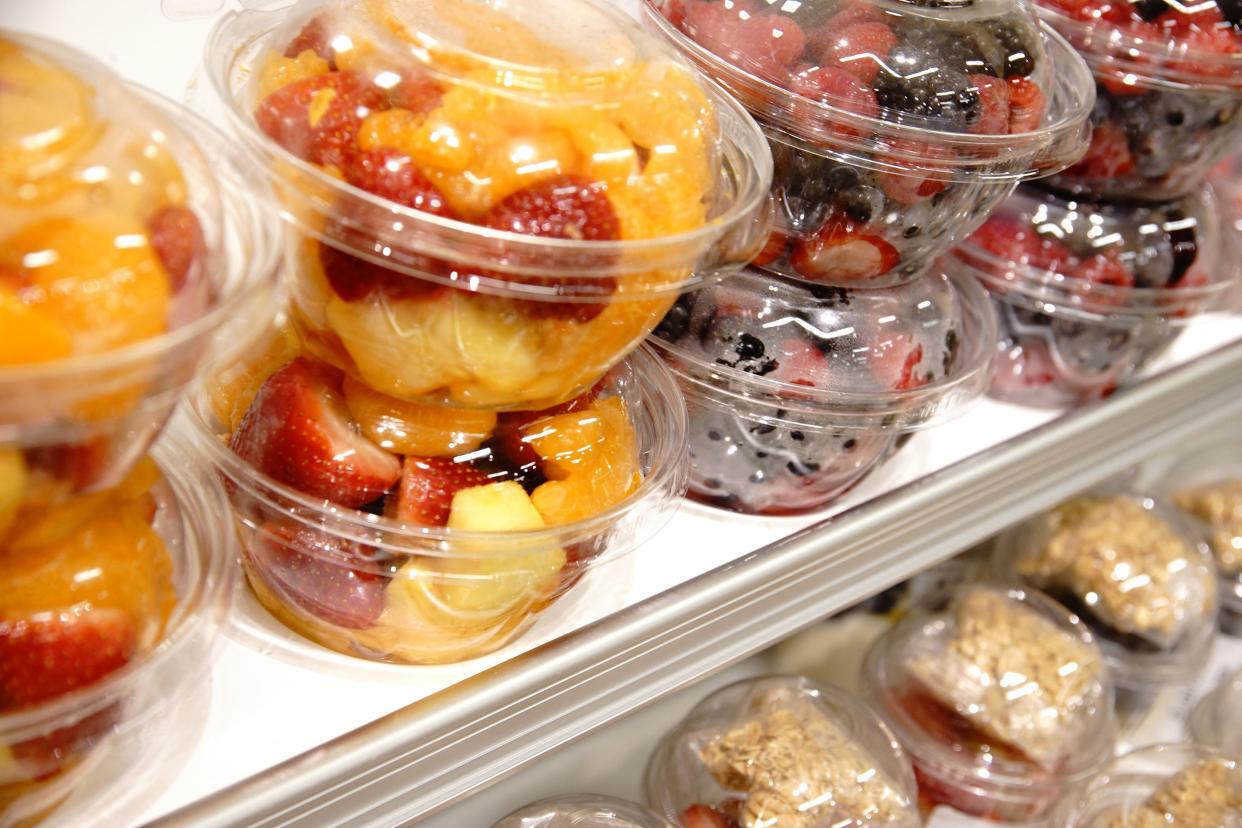 ready to eat cut fruit in containers on a supermarket shelf