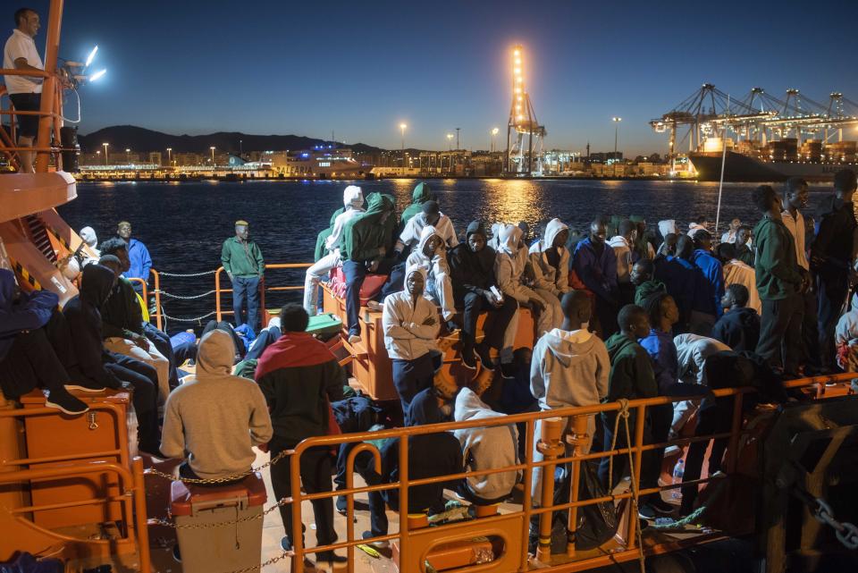 In this photo taken late Wednesday, July 25, 2018, migrants spend the night onboard a Spanish Maritime Rescue Service boat docked at the port of Algeciras, southern Spain, after being rescued in the Strait of Gibraltar. Around 800 migrants stormed border fences separating Spain's North African enclave of Ceuta from Morocco to get into Europe, police said Thursday. (AP Photo/Marcos Moreno)