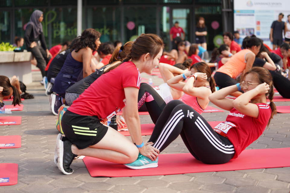 Participants in the Great Eastern Women's IPPT event doing sit-ups.