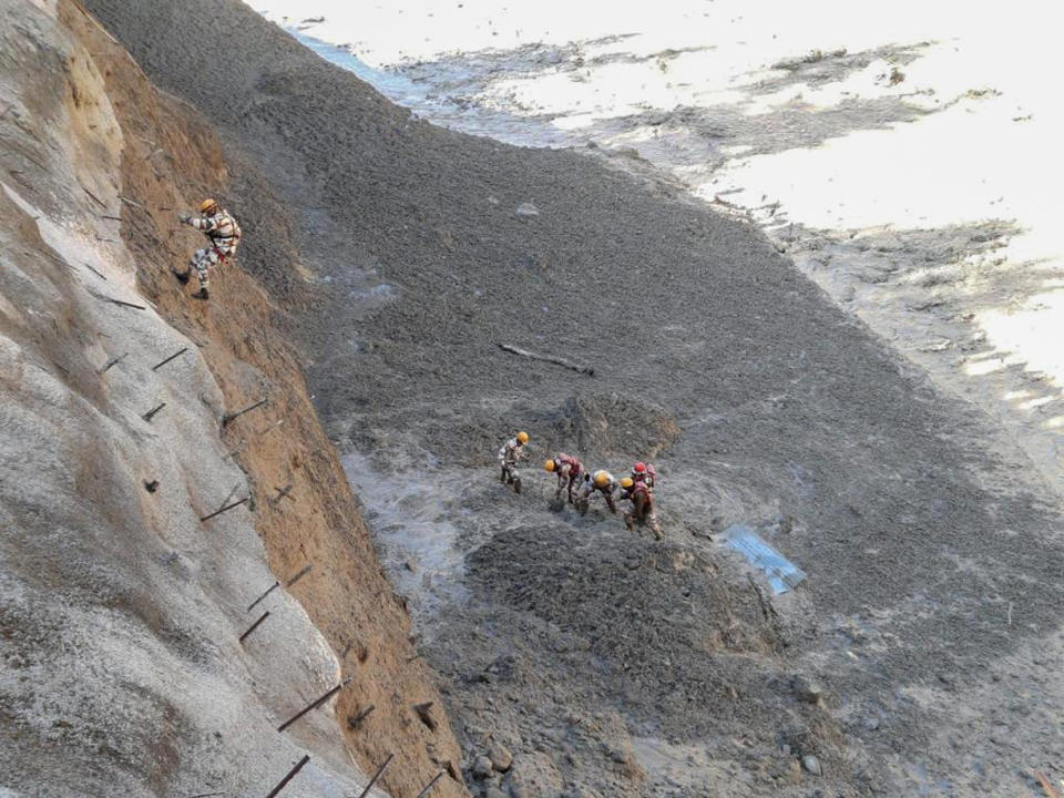 This photograph provided by Indo Tibetan Border Police (ITBP) shows ITBP personnel begin rescue work after a portion of Nanda Devi glacier broke off in Tapovan area of the northern state of Uttarakhand sending a massive flood of water, mud and debris into areas below, India, Sunday, Feb.7, 2021. (Indo Tibetan Border Police via AP)