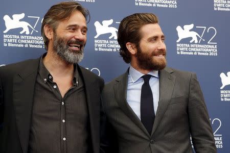 Cast member Jake Gyllenhaal (R) and director Baltasar Kormakur pose during the photocall for the movie "Everest" at the 72nd Venice Film Festival, northern Italy September 2, 2015. REUTERS/Stefano Rellandini