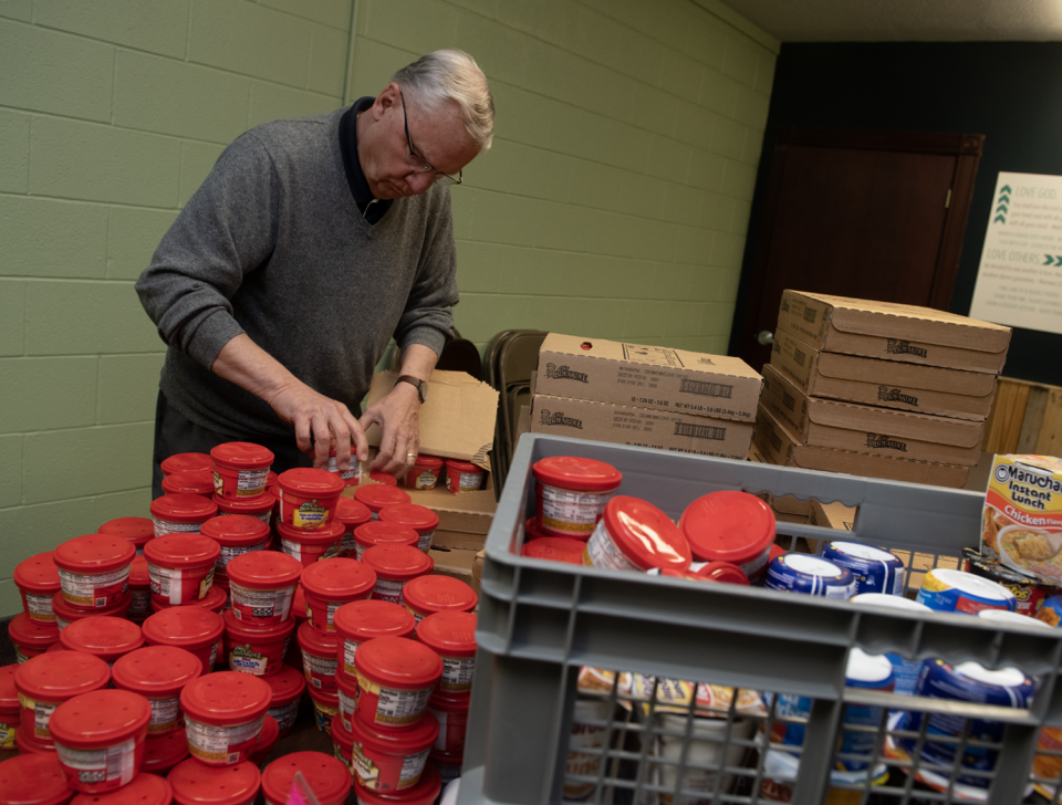 Bill Wisniewski unpacks microwave dinners at Portage Community Chapel on April 27.